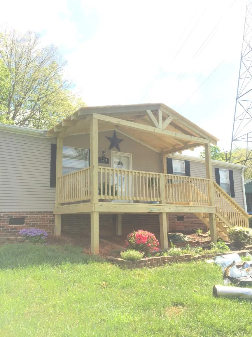 New gabled porch roof and deck railing added to a ranch home in West Bloomfield